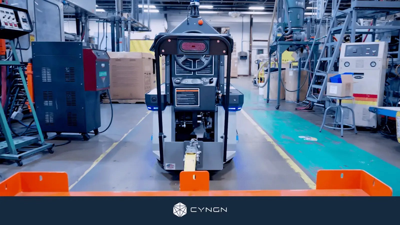 A Cyngn autonomous industrial vehicle moves through a factory floor